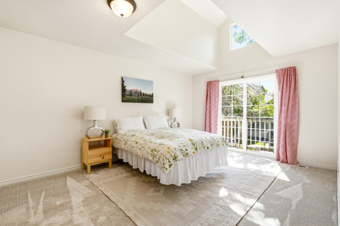 A view of the primary suite with vaulted ceiling and dormer window in the home for sale at 828 Kane Dr Unit F33 in Longmont, Colorado.