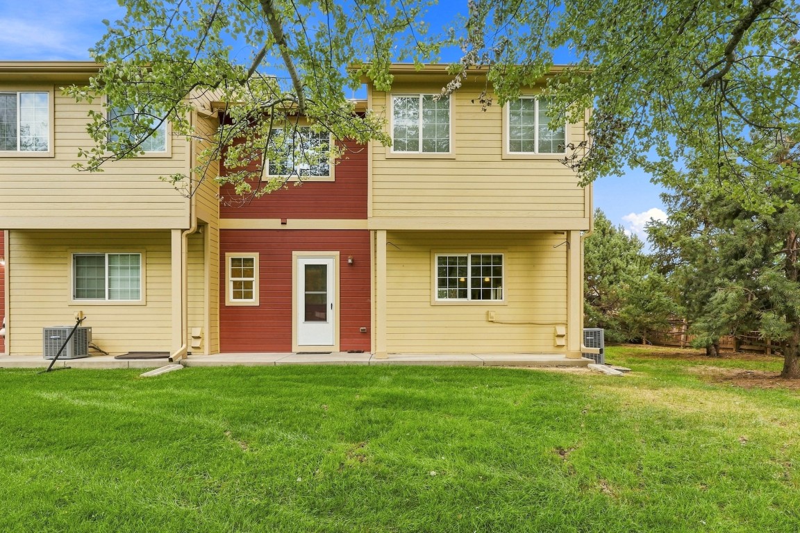 An exterior, ground level view of the backdoor of the condo for sale at 833 S Coffman St Unit 52 in Longmont, Colorado.