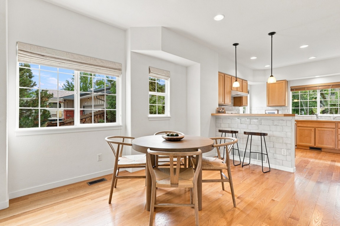 An interior view of the dining room and kitchen in the condo for sale at 833 S Coffman St Unit 52 in Longmont, Colorado.